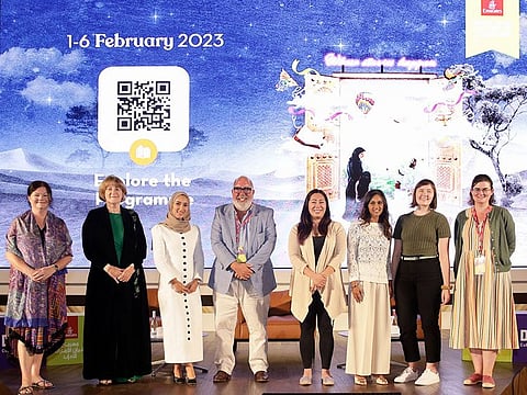 Winners of the Emirates LitFest Writing Prize standing for a photographer after receiving their awards