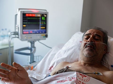 Huseyin Berber, 62, a survivor who was rescued after being trapped under the rubble for 187 hours in Antakya, speaks to media and doctors as he receives medical attention at Mersin City hospital, in the aftermath of a deadly earthquake, in Turkey, February 15, 2023.