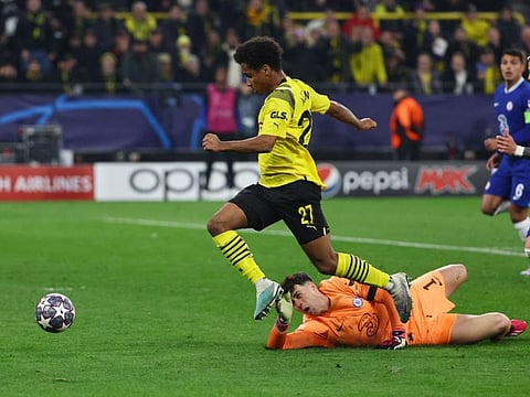 Borussia Dortmund's Karim Adeyemi scores their first goal past Chelsea's Kepa Arrizabalaga.