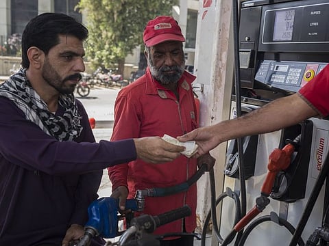 A customer pays for petrol at a petrol station in Karachi.