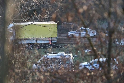 This photograph taken on February 17, 2023, on the outskirts of the village of Lokorsko, some 20 kilometres (12 miles) north-east of Sofia, shows a general view of the discovery of 18 dead migrants in the rear of an abandoned truck.