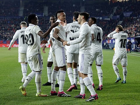 Real Madrid's Marco Asensio celebrates scoring their second goal with teammate Vinicius Junior.