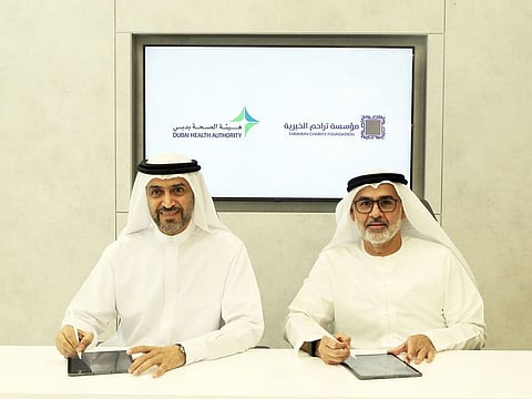 Awadh Seghayer Al Ketbi, DHA Director-General and Khalid Abdullah Al Qassim, Chairman of the Board of Directors of the Tarahum Charity Foundation after signing the contract in Dubai.