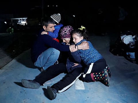People react after an earthquake in Antakya in Hatay province, Turkey.