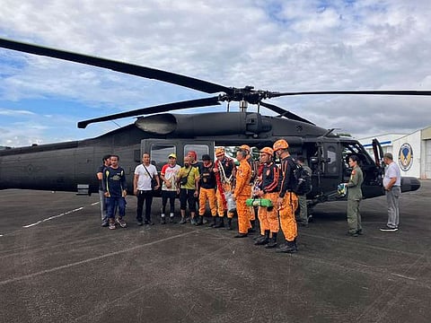 Rescuers stand beside a helicopter as they prepare their search for passengers of a Cessna 340 aircraft with registry number RP-C2080 at Camalig town, Albay province, southeast of Manila, Philippines.