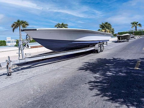 Boats wrongly parked on right-of-way next of a sidewalk at a beach in Dubai