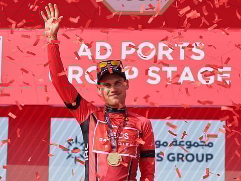 Lucas Plapp of Ineos Grenadiers team celebrates on the podium after being awarded the red jersey on the second stage of the UAE cycling tour, in Abu Dhabi.