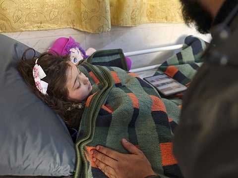 Syrian girl Sham, 9, who was rescued after 40 hours under the rubble of a deadly earthquake, in a hospital in the rebel-held northwestern city of Idlib, on February 17, 2023.