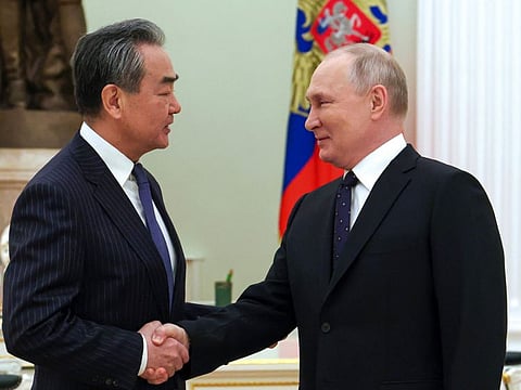 Russian President Vladimir Putin greets Chinese Communist Party's foreign policy chief Wang Yi during their meeting at the Kremlin in Moscow, Russia, Wednesday, Feb. 22, 2023.
