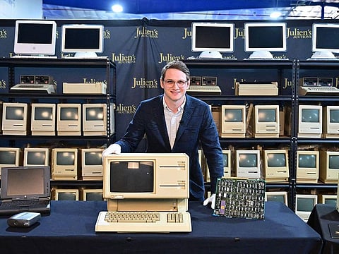 Erik Rosenblum, NFT Development Strategist at Julien's Auctions, poses behind the Apple Lisa, one of the first personal computers released in 1983 on display with motherboard.