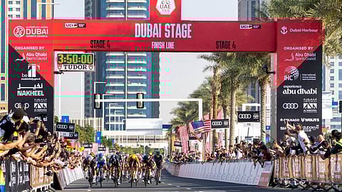 Riders sprinting towards the finish line in Stage Four of UAE Tour.