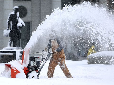 Capitol groundskeeper Mike Nielson clears the walkways at the Capitol in Salt Lake City, Utah, following a snowstorm on Wednesday, Feb. 22, 2023.