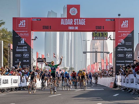 Tim Merlier crossed the finish line in first place in stage 6 of the UAE Tour, in Abu Dhabi.