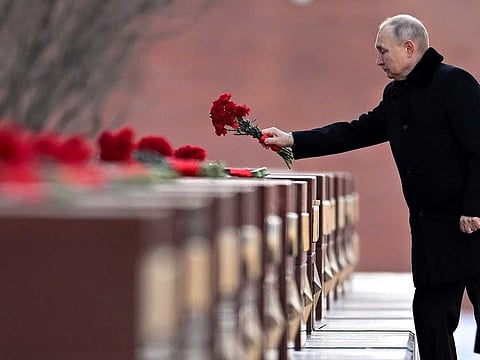 Russian President Vladimir Putin attends a wreath-laying ceremony at the Tomb of the Unknown Soldier, near the Kremlin Wall during the national celebrations of the "Defender of the Fatherland Day" in Moscow, Russia, Thursday, Feb. 23, 2023.