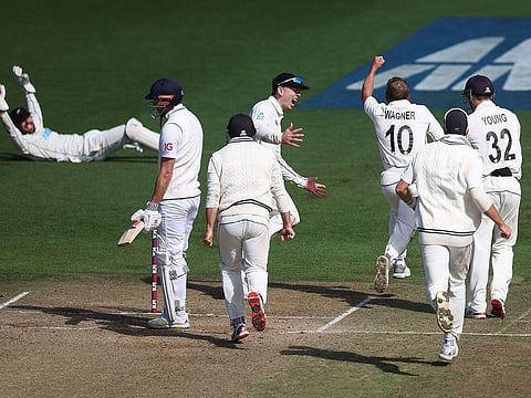 New Zealand's Neil Wagner (C) celebrates taking the final wicket of England's James Anderson (centre L) to win during day five of the second cricket Test match between New Zealand and England at the Basin Reserve in Wellington.