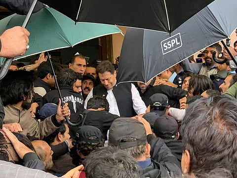 Pakistan's former Prime Minister Imran Khan (centre) leaves after appearing at the court in Islamabad on February 28, 2023. (Photo by Farooq NAEEM / AFP)