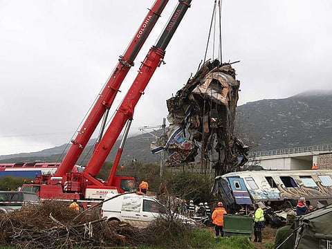 Cranes remove debris after a trains' collision in Tempe, about 376 kilometres north of Athens, near Larissa city, Greece, Thursday, March 2, 2023.