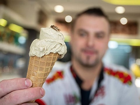 Thomas Micolino, owner of Eiscafe Rino, holds an ice cream cone in Rottenburg am Neckar, Germany.