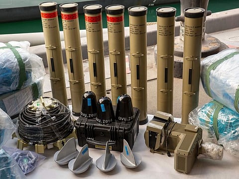 In this photo from the US Army, anti-tank missiles and medium-range ballistic missile components seized by the United Kingdom Royal Navy sit pier side at an undisclosed location in the Middle East on Feb. 26, 2023.