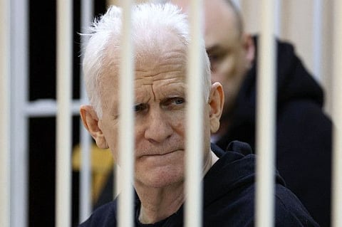 In this file photo taken on January 05, 2023 Nobel Prize winner Ales Bialiatski is seen in the defendants' cage in the courtroom at the start of the hearing in Minsk.