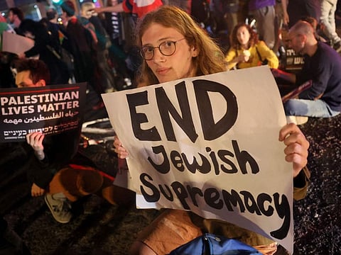 People demonstrate in Tel Aviv against Israeli settlers attack on a Palestinian town.