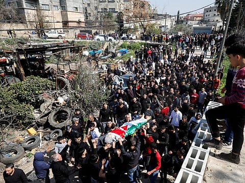 Mourners carry the body of 15-year Palestinian Mohammad Saleem who was shot and killed during clashes by Israeli troops, at his funeral in Azzoun on March 3.