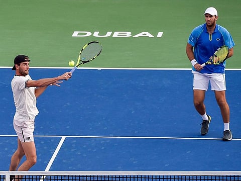 Maxime Cressy of the United States and Fabrice Martin of France in action in the doubles final of the ATP Dubai Duty Free Tennis Championship on March 4, 2023. Teaming up for the first time, the pair won the title in straight sets.