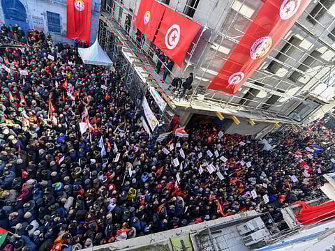 Demonstrators lift placards during an anti-government rally called for by the powerful trades union federation UGTT in Tunis, on March 4, 2023.
