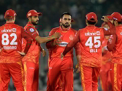 Islamabad United's Faheem Ashraf (centre) celebrates with teammates after taking the wicket of Karachi Kings' Shoaib Malik (not pictured) during the Pakistan Super League (PSL) T20 cricket match at the Rawalpindi Cricket Stadium, in Rawalpindi .