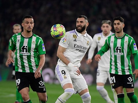 Real Madrid's forward Karim Benzema (centre) vies with Real Betis' defender Luiz Felipe (left) during the Spanish League match at the Benito Villamarin stadium in Seville.