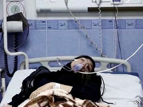 A young woman lies in hospital after reports of poisoning at an unspecified location in Iran in this still image from video from March 2, 2023.