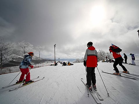 Skiers and snowboarders gathering at a ski course overlooking Lake Inawashiro at the Alts Bandai Snow Park & Resort in Bandai Town, Fukushima prefecture.