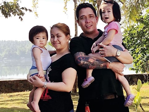 Frederick Valiente who donated his kidney posing for a photograph with his wife Maria Theresa Coronel and two children Maria Theresa Coronel