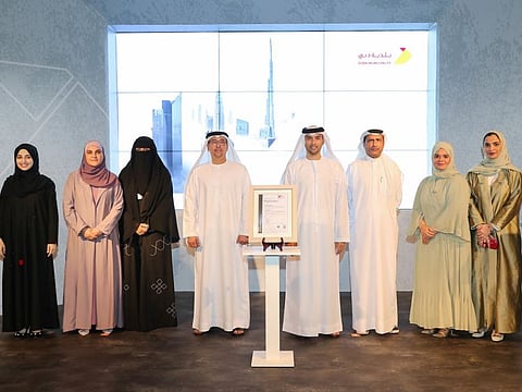 Dubai Municipality officials standing for a photo after receiving six new Certificates of Conformity (CoC) with international ISO standards and British specifications, and renewing 22 international certificates in different fields and activities.