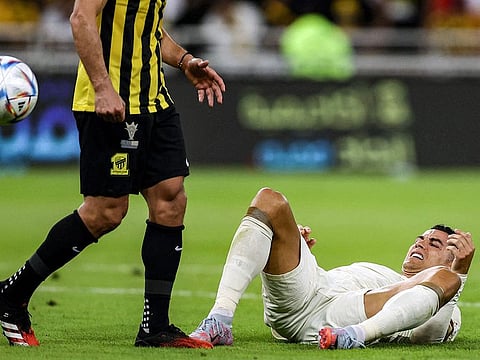 Al Nassr's Portuguese forward Cristiano Ronaldo reacts while on the ground during the Saudi Pro League football match between Al Ittihad and Al Nassr at King Abdullah Sport City Stadium in Jeddah on March 9, 2023.