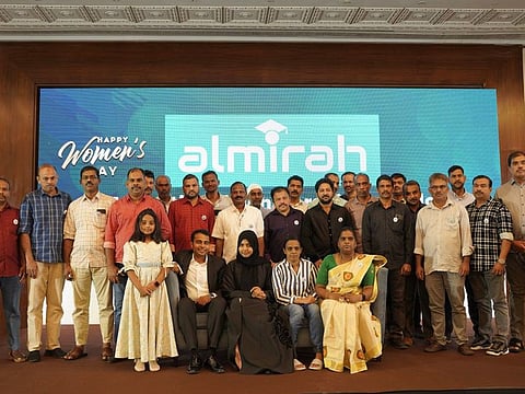 Haseena Nishad, Nishad Hussain (seated left) and their daughter Almirah (standing next to them) with the 25 proud expats who received the educational scholarship for their brilliant daughters on the International Women’s Day in Dubai on Wednesday