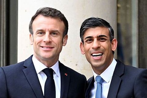 France's President Emmanuel Macron (left) greets Britain's Prime Minister Rishi Sunak as he arrives for a meeting on the occasion of 36th Franco-British bilateral summit at the Elysee Palace, on March 10, 2023.
