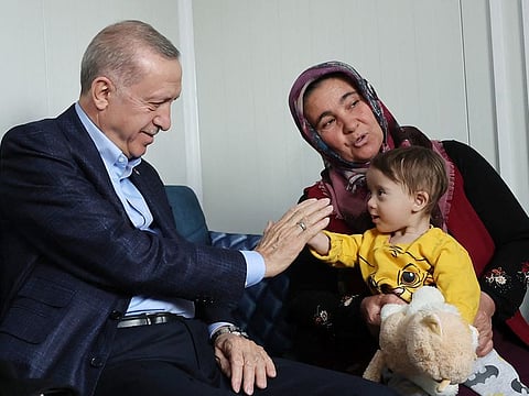 Turkish President Recep Tayyip Erdogan meets with people affected by the February 6 earthquake.