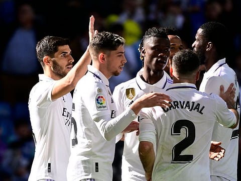 Real Madrid's midfielder Marco Asensio (left) celebrates with teammates scoring his team's third goal during the Spanish league match against RCD Espanyol at the Santiago Bernabeu stadium in Madrid.