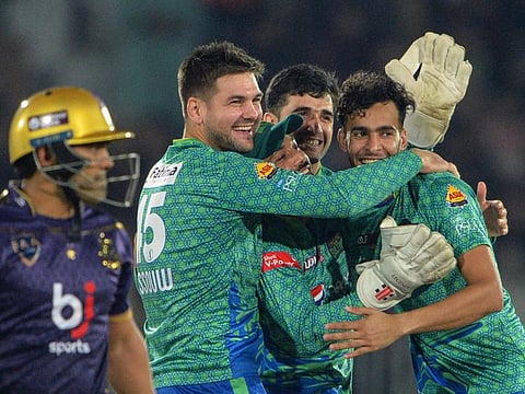 Multan Sultans' Abbas Afridi (right) celebrates the wicket of Quetta Gladiators' Umar Akmal (left) as he walks back during the Pakistan Super League (PSL) Twenty20 cricket match at the Rawalpindi Cricket Stadium, in Rawalpindi.