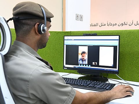A GDRFA Dubai official guides a customer on the procedures though video call