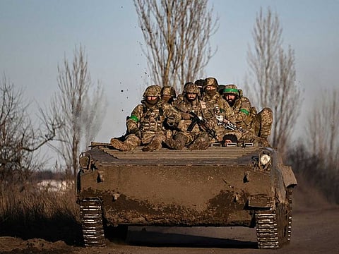 Ukrainian servicemen sit on a BMP military vehicle as they move towards Bakhmut in the region of Donbas, on March 13, 2023, amid the Russian attack of Ukraine.