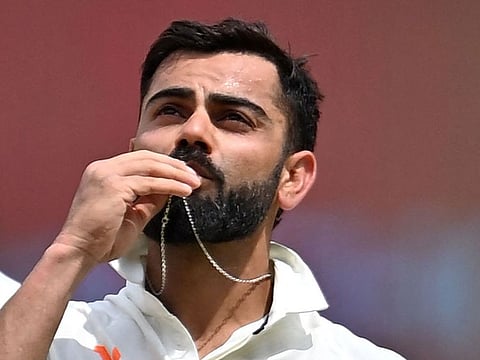 Virat Kohli celebrates after scoring his century against Australia in Ahmedabad on Sunday.