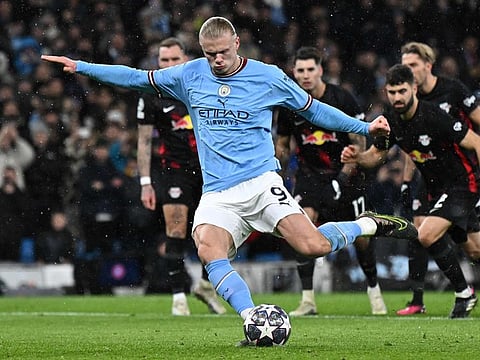 Manchester City striker Erling Haaland shoots from the penalty spot to score the team's opening goal during the UEFA Champions League round of 16 second-leg match against RB Leipzig at the Etihad Stadium in Manchester, north west England.