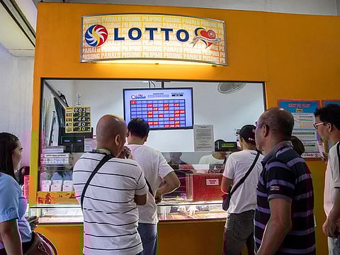 Philippine lottery ticket buyers form a queue outside a ticket outlet. The winners have one year to claim their prize money at the PCSO main office in Mandaluyong City (Metro Manila) upon presentation of the winning ticket and two identification cards.