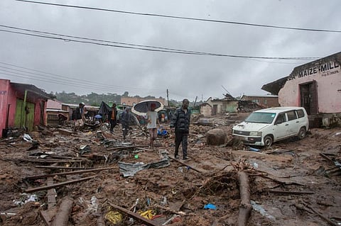People wander in the water flooded Chimwankhunda location in Blantyre, Malawi, on March 14, 2023 following heavy rains caused by cyclone Freddy.
