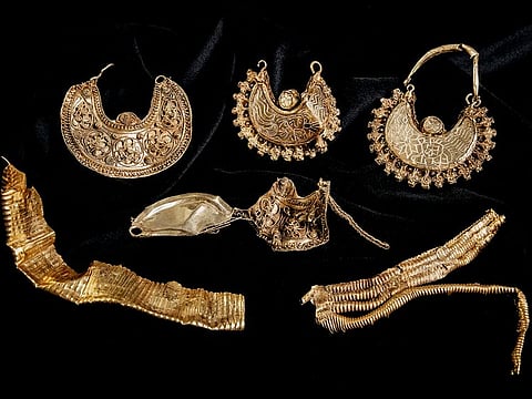 Part of the 1000-year-old medieval treasure discovered in Hoogwoud, Netherlands, consisting of jewellery and silver coins.