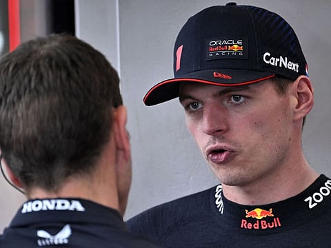 Red Bull Racing's Max Verstappen (right) chats with a mechanic during the first practice session at the Jeddah Corniche Circuit on Friday