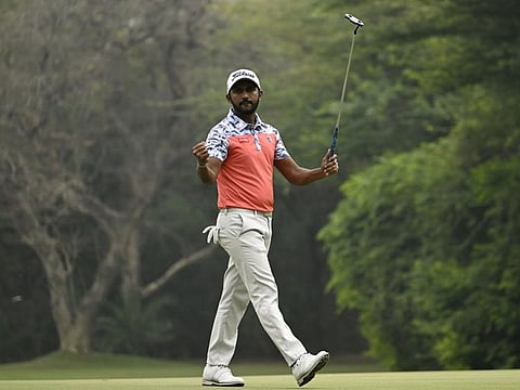 Chikkarangappa S. of India celebrates a birdie putt on his last hole, the 9th, to lead by three shots after two rounds at Delhi Golf Club on the Asian Tour
