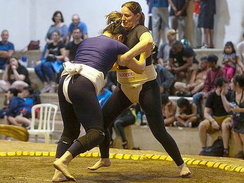 Brazilian sumo wrestler Valéria Dall'Olio (R) fights during a Brazilian sumo championship bout, a qualifier for the South American championship, in Sao Paulo, Brazil, on March 12, 2023.